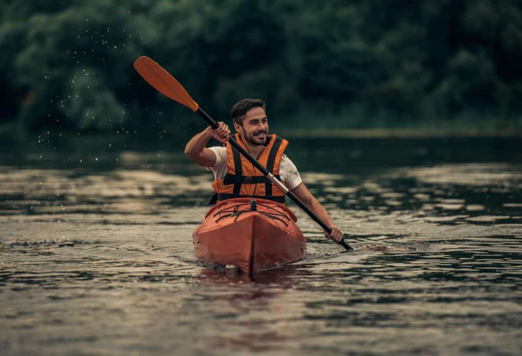 Man kayaking near Nashville, TN, during addiction recovery program.