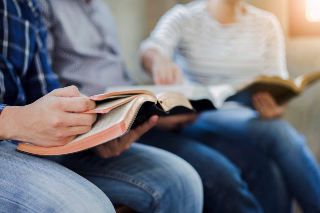 people reading the Bible in a group
