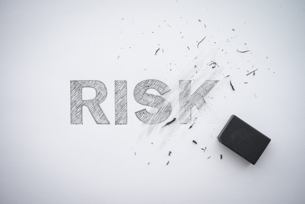the word risk on a whitw backgrounf partially erased to symbolism harm reduction's effects of reducing harmful and risky effects of addiction