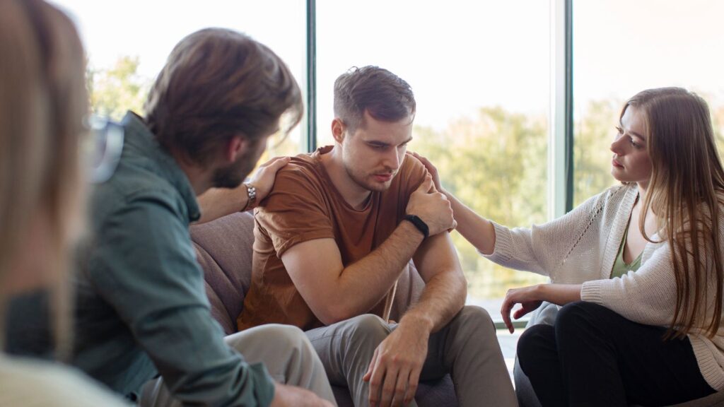 A group of people helping someone with prescription drug addiction.