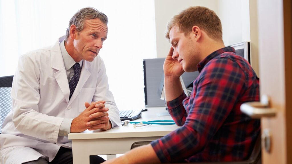 A young man struggling with prescription drug addiction receiving help from a doctor.