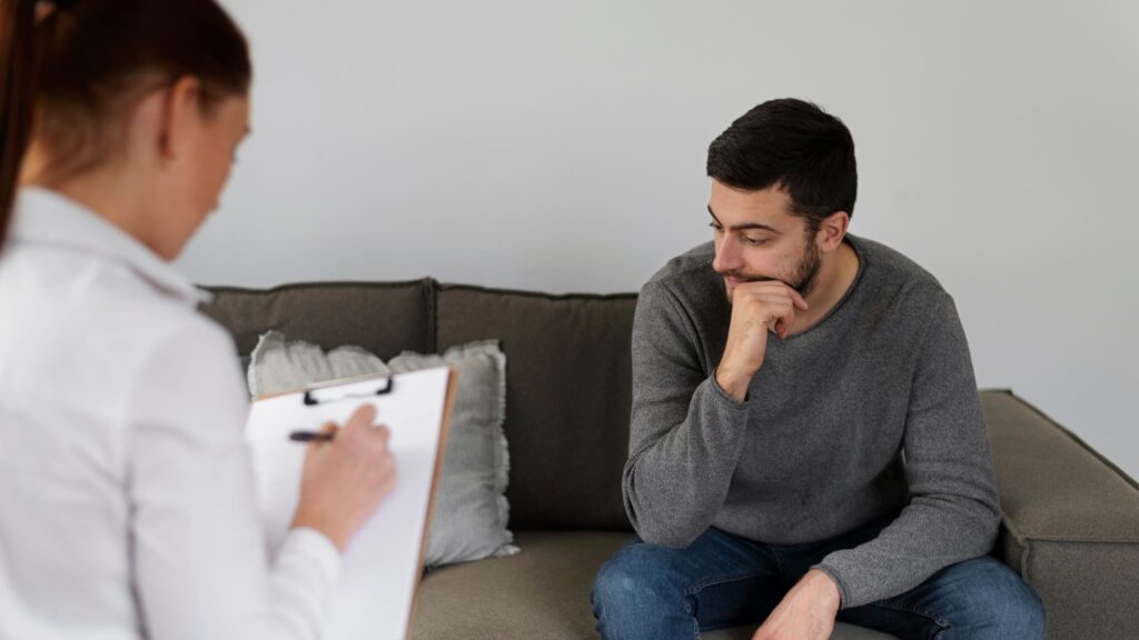 A therapist consults with a client during heroin withdrawal.