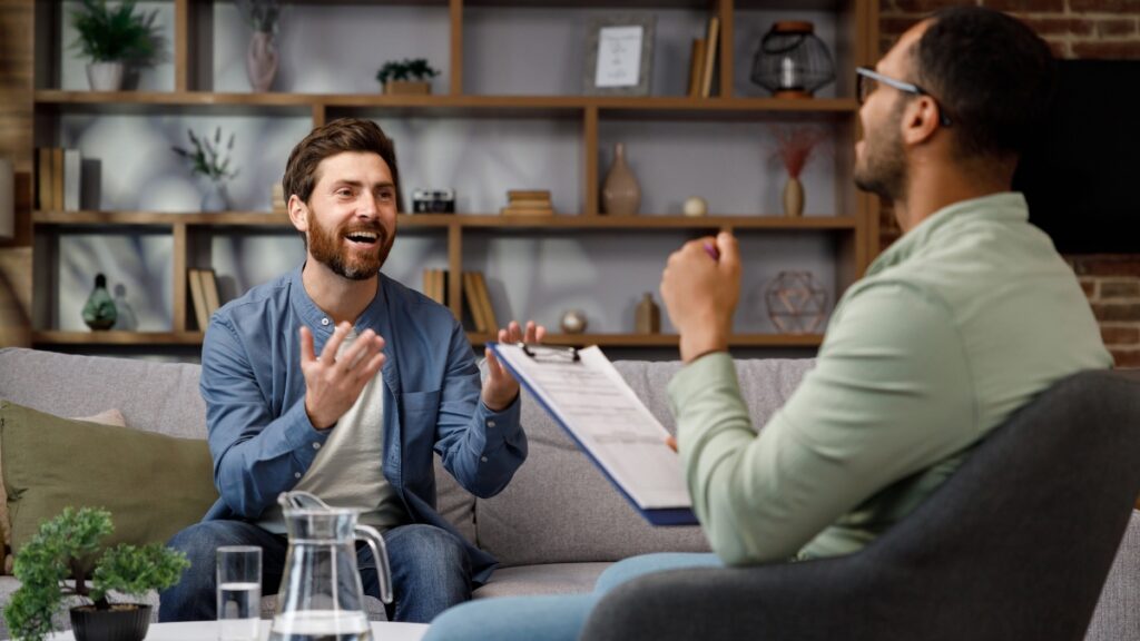 A man shares his experience during a personalized individual treatment session.