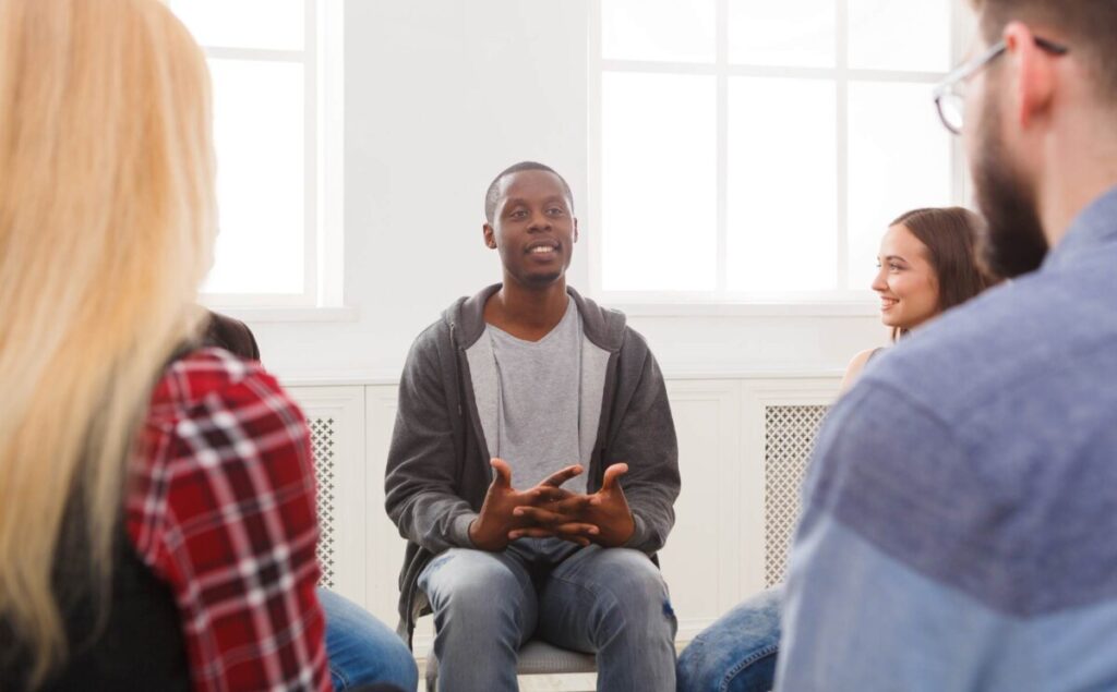 Man speaking openly during a session at one of the Christian rehab centers in Missouri.