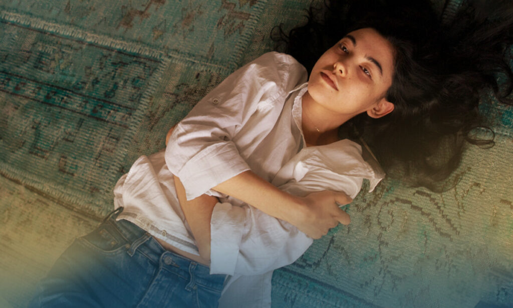 Woman laying on the floor holding her body